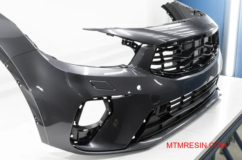 A painted automotive bumper made from reinforced polymer, showcasing its high-quality, durable Class-A finish.