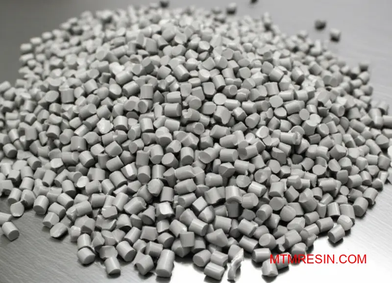 A close-up macro shot of grey Daplen EE188HP material pellets on an industrial surface.