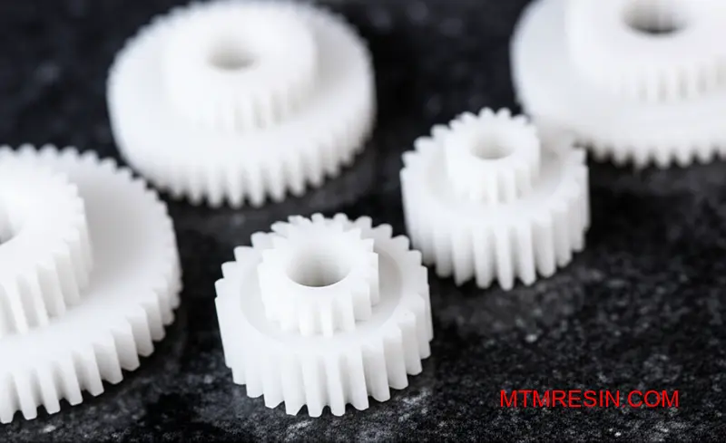 An assembly of high-precision white polyoxymethylene gears and bushings showcasing dimensional stability.