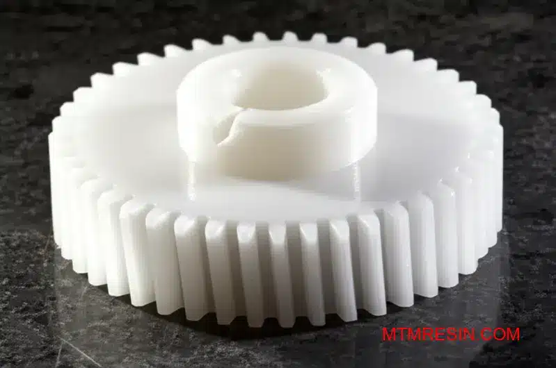 A cracked white acetyl gear shows the risk of using inferior generic POM material.