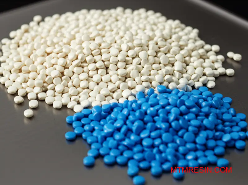 Piles of natural ASA polymer granules next to blue colorant masterbatch for plastic parts.